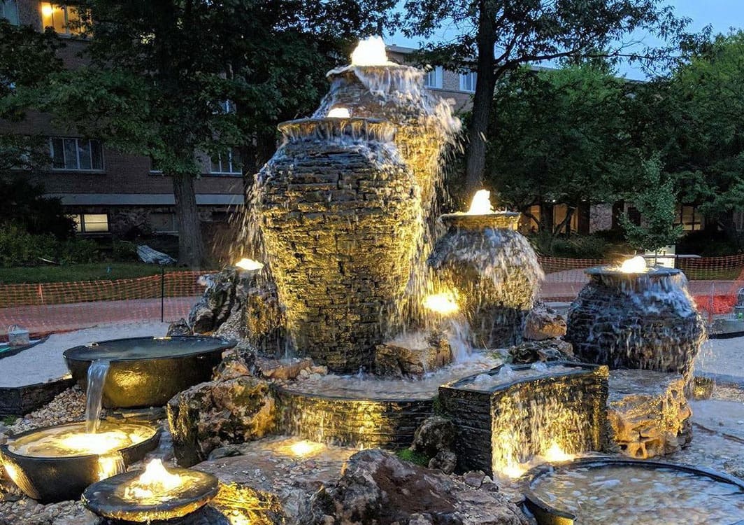 Basalt column fountain set in a decorative gravel bed