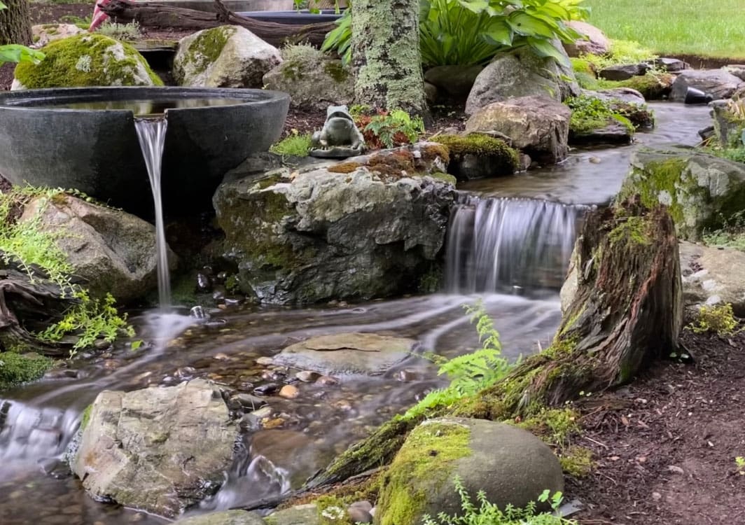 Basalt column fountain framed by perennials