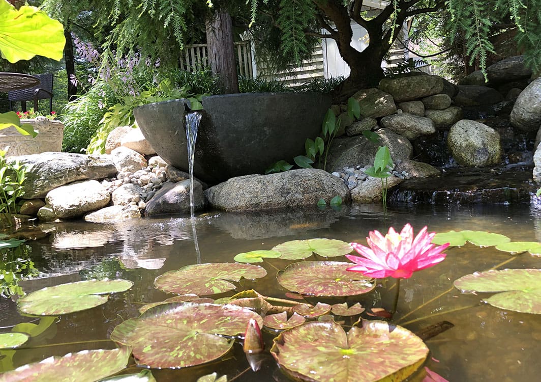 Sphere fountain flowing over a cobble base