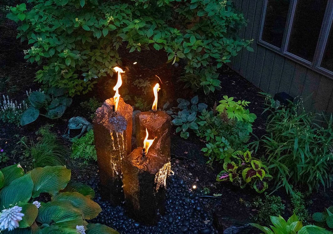 Bubbling urn fountain beside garden seating