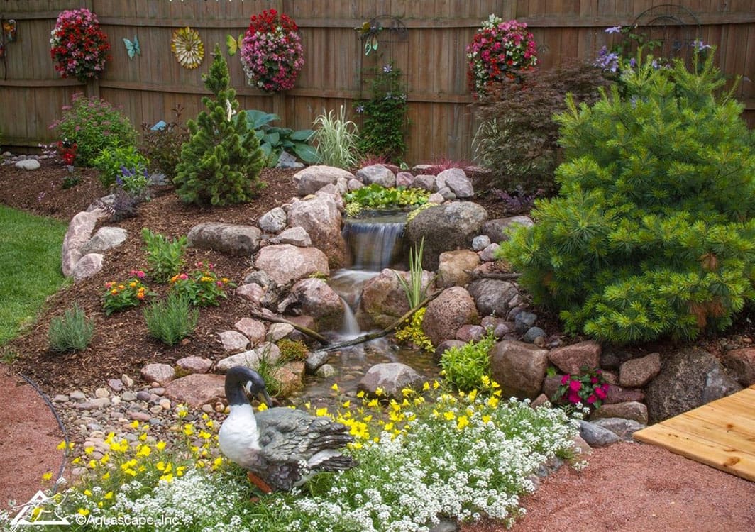 Pond and waterfall integrated with an existing garden bed