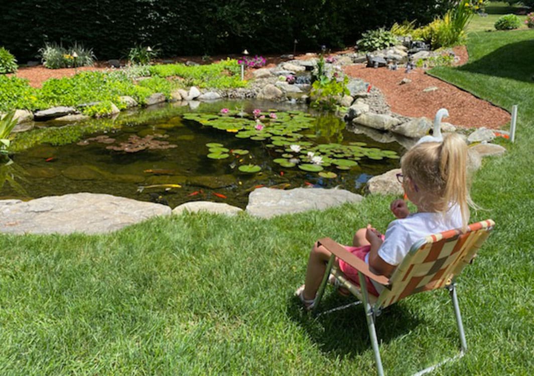 Multi-tier ecosystem pond with waterfall nearing completion