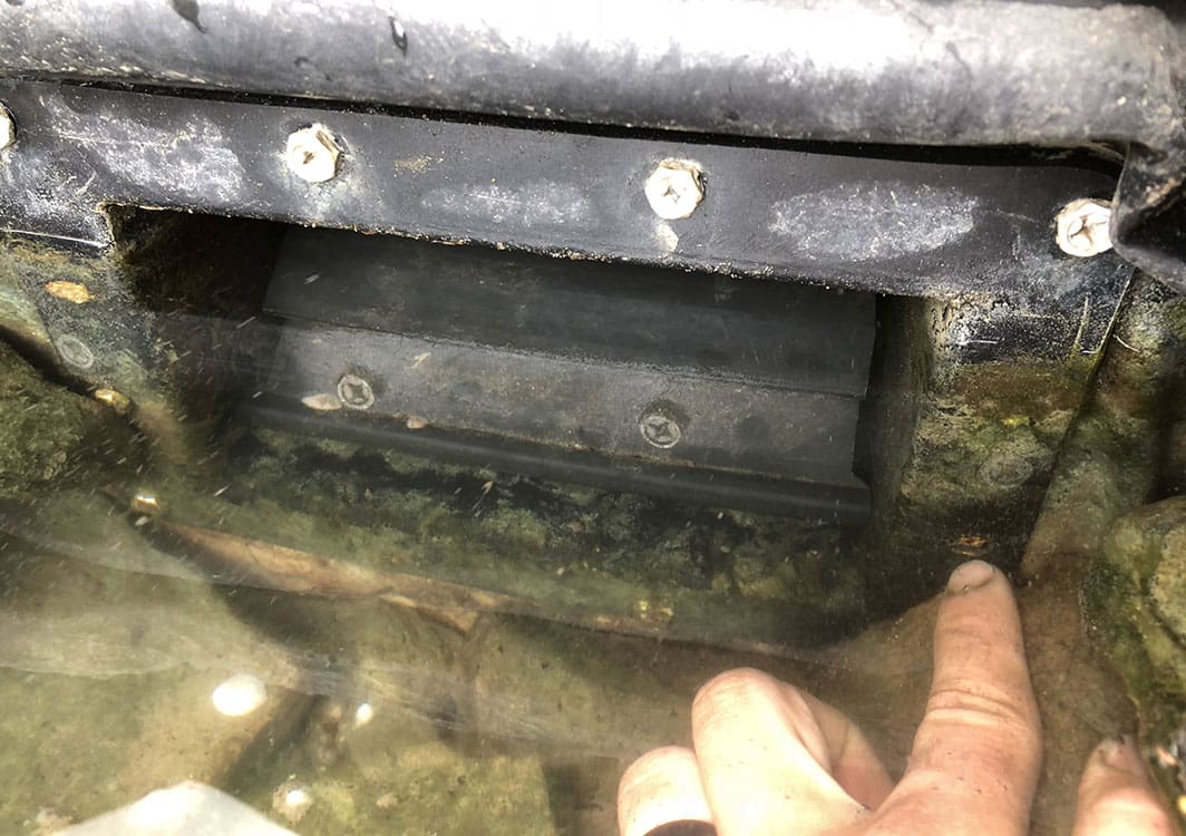 Cracked pond liner exposed during a leak repair