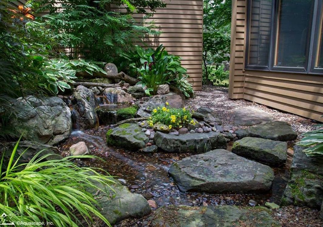 Pondless waterfall in a front yard landscape bed