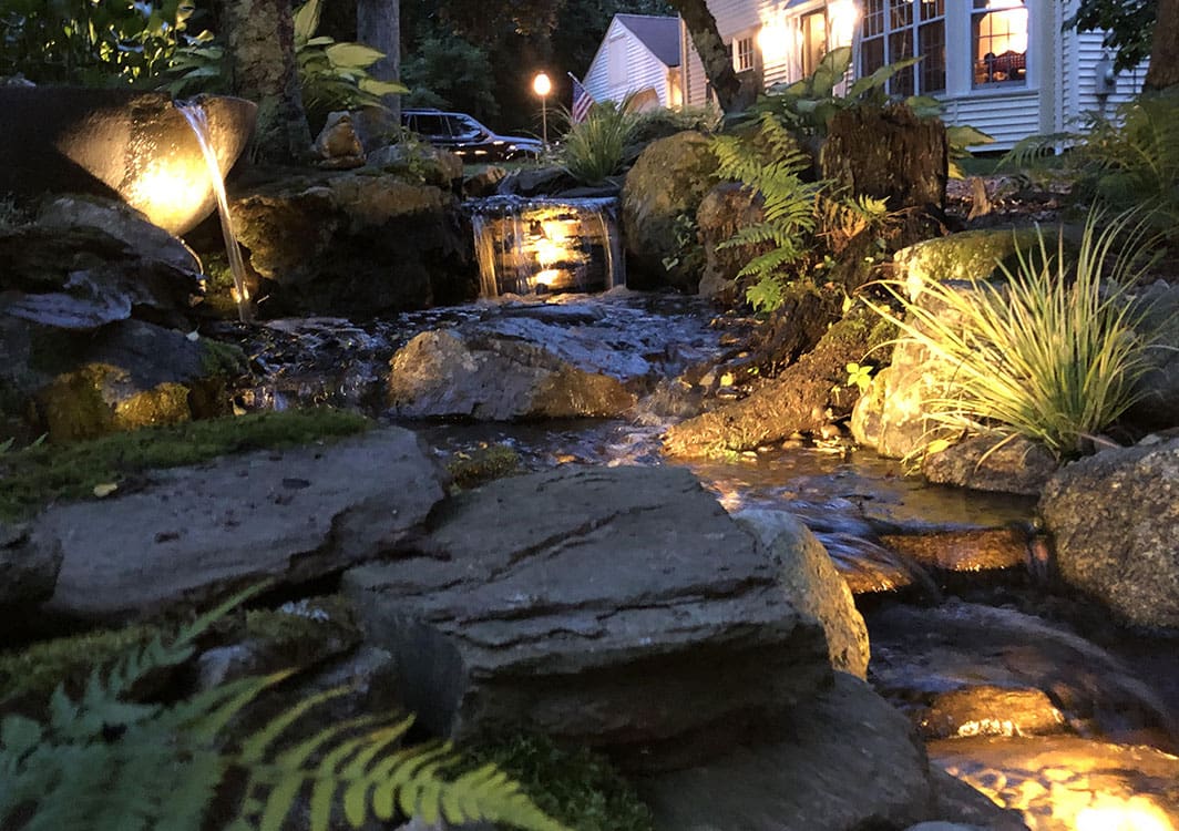 Multi-drop pondless waterfall in a residential backyard