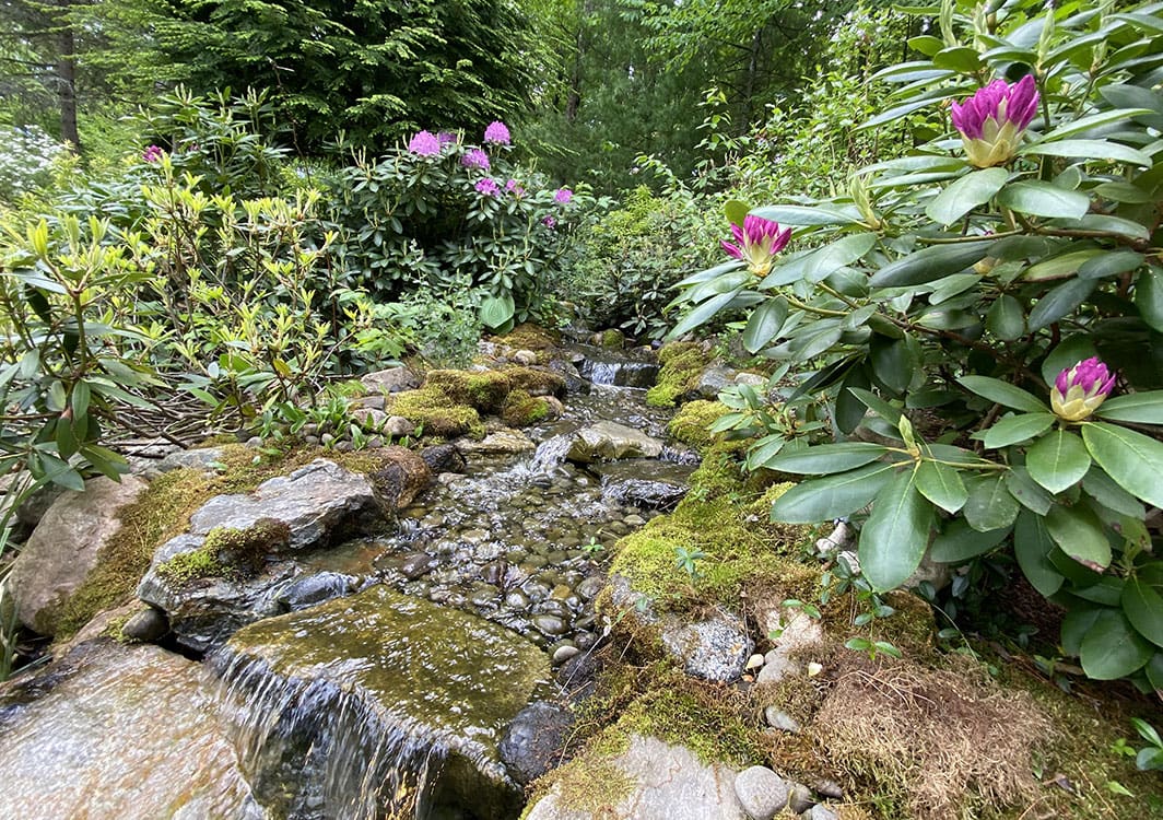 Boulder placement for a pondless waterfall in progress