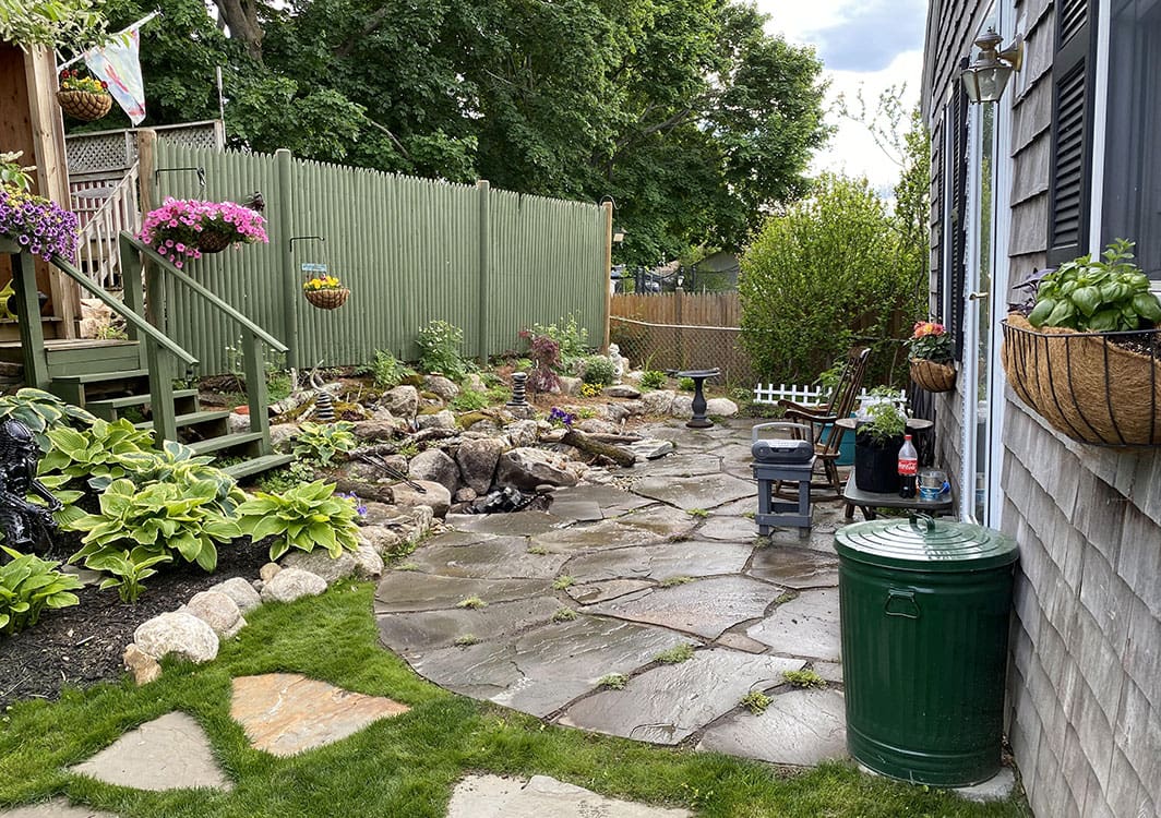 Pondless waterfall feature near a home entryway