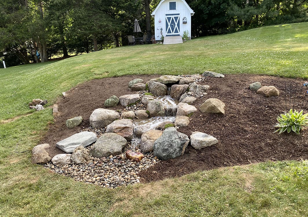 Pondless waterfall spilling into a hidden gravel basin