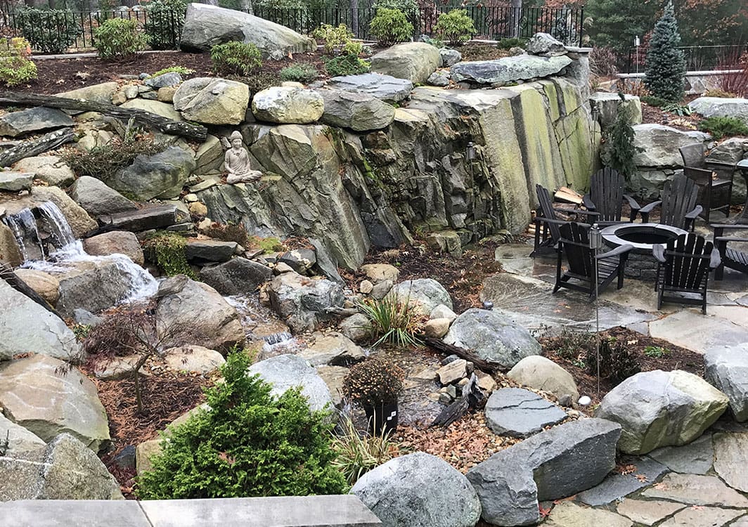 Pondless waterfall cascading over stacked New England fieldstone