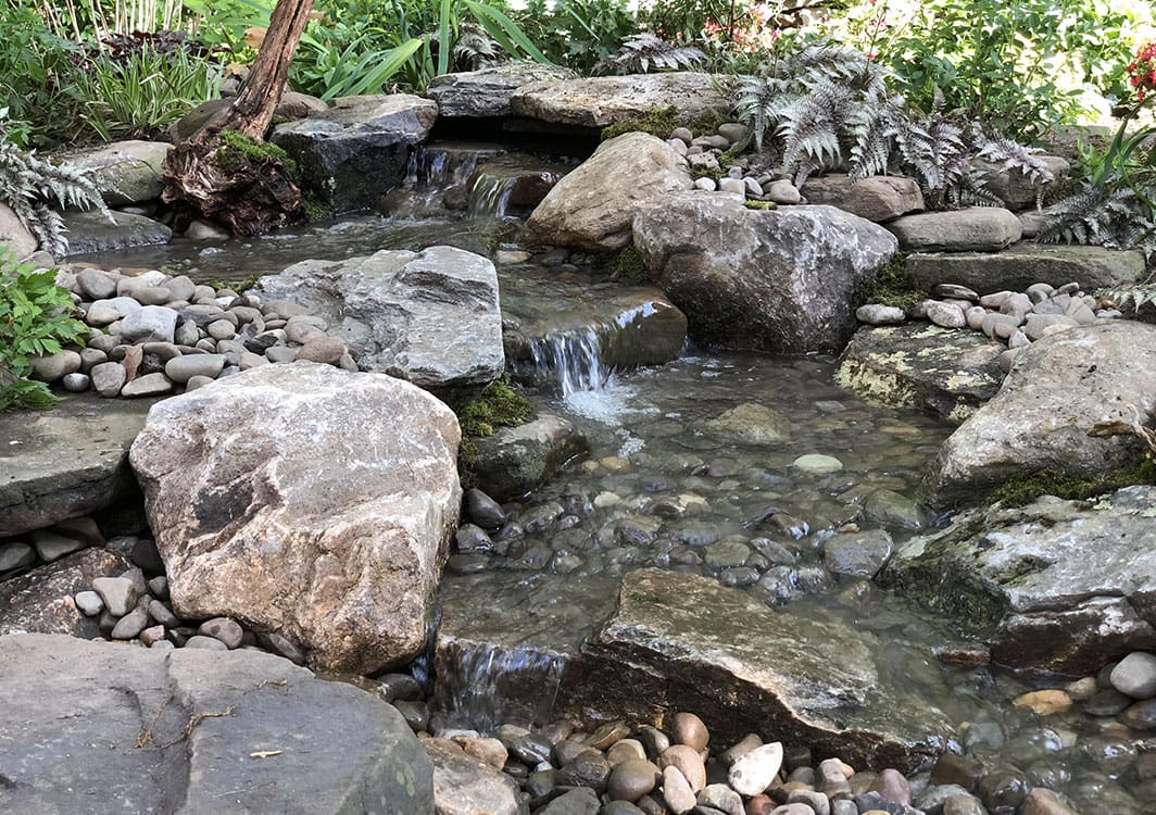 Pondless waterfall installed for a low maintenance yard