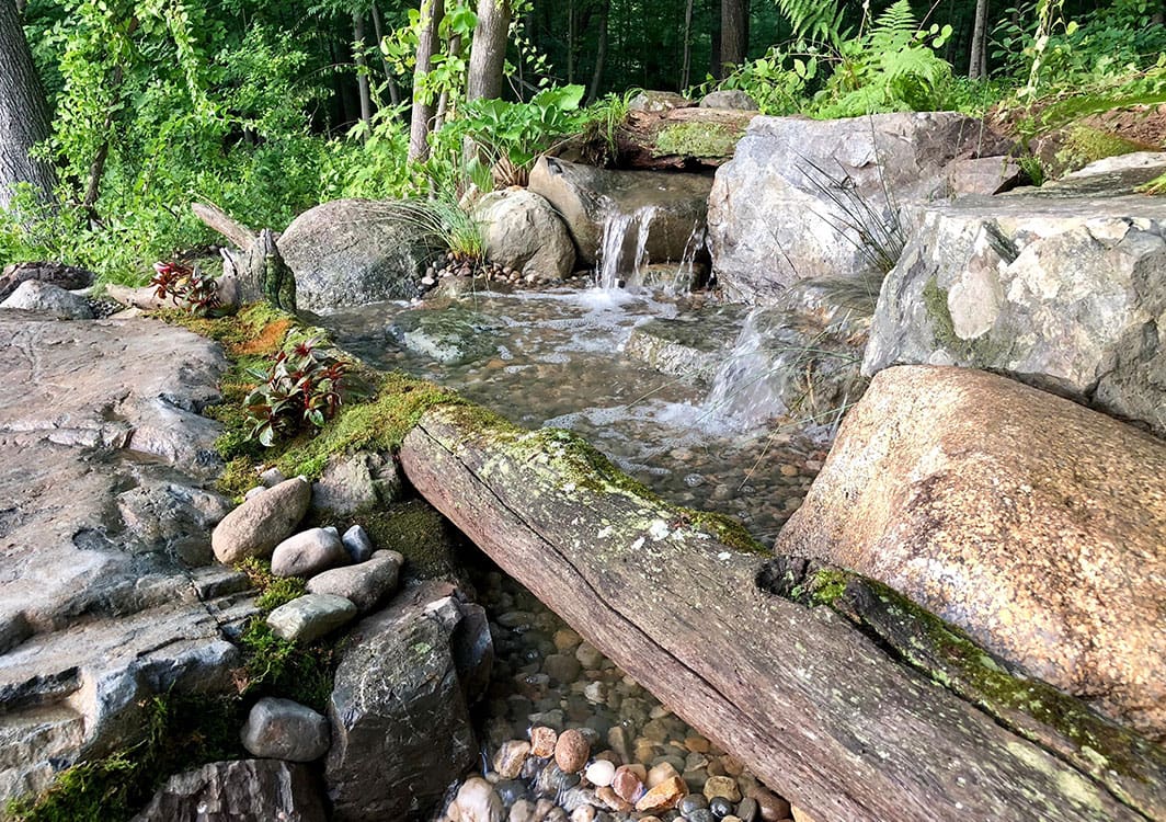 Pondless waterfall tucked into a corner of the yard