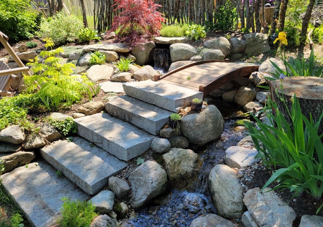 Pondless stream with decorative gravel and boulder edging