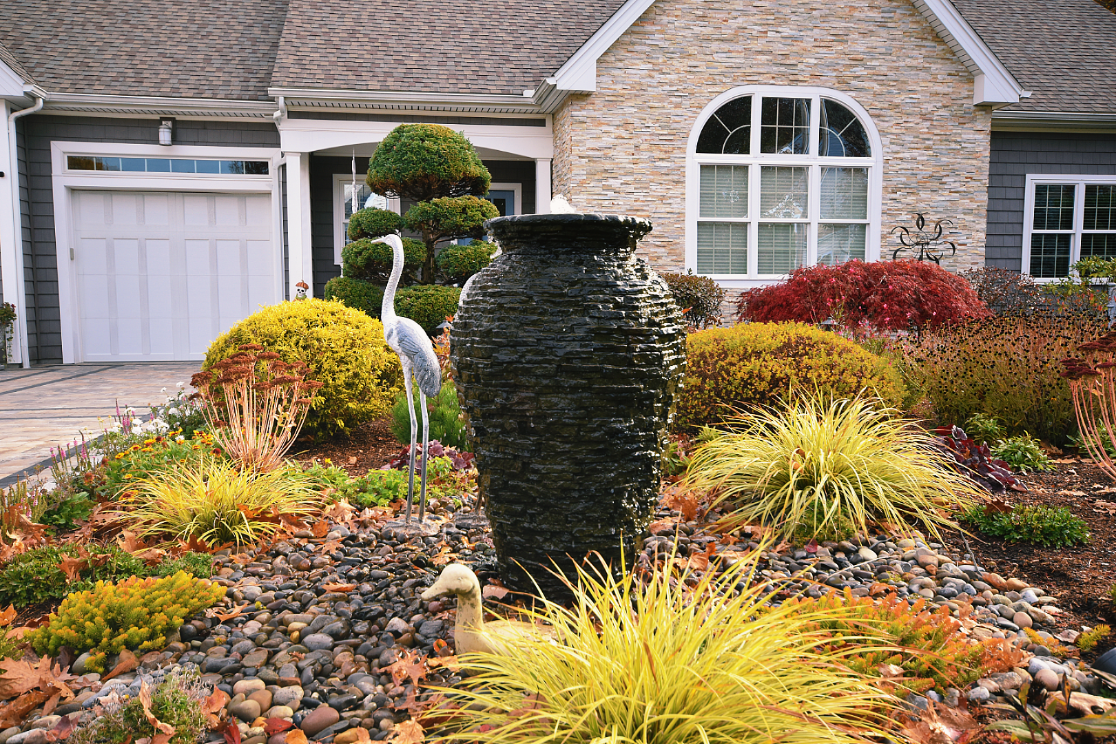 Beautiful garden with fountain and decorative statue.